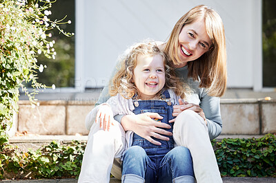 Buy stock photo Portrait of a mother and daughter affectionately bonding in the backyard at home