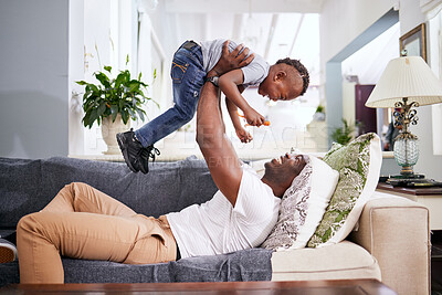 Buy stock photo Black family, airplane and father with son on a sofa with love, lifting and playing in their home together. Flying, child and fun with parent on sofa, laugh and play, bonding and games in living room