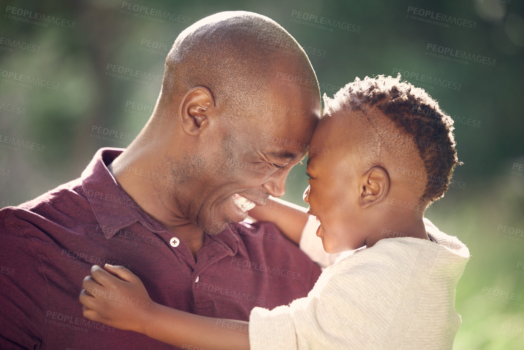 Buy stock photo Father, son and forehead in outdoor for laugh, affection and support in nature garden to connect. Black family, trust and embrace for security in relationship, travel and care on vacation in woods