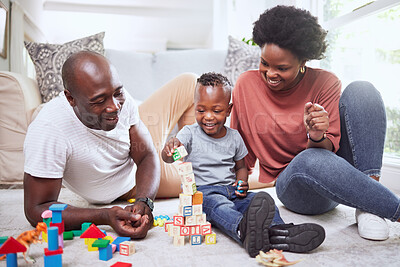 Buy stock photo Building blocks, games and black family playing on a living room floor happy, love and bonding in their home. Child development, learning and kid with parents in lounge with alphabet, shape and toys