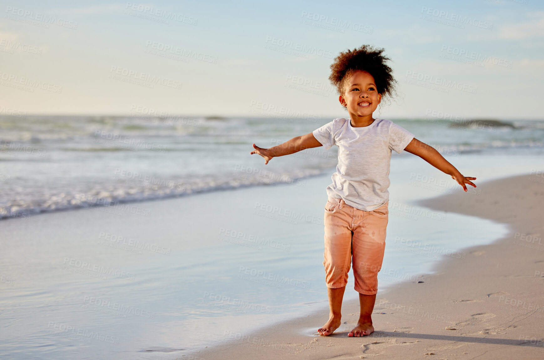 Buy stock photo Child, girl and open arms on beach for freedom, relax and happiness on summer holiday or vacation. Smile, female perosn and travel adventure to sea for ocean waves, peace and celebration for weekend