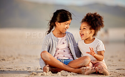 Buy stock photo Shot of  two sisters spending time together at the beach