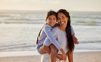 Buy stock photo Shot of a mother carrying her daughter at the beach