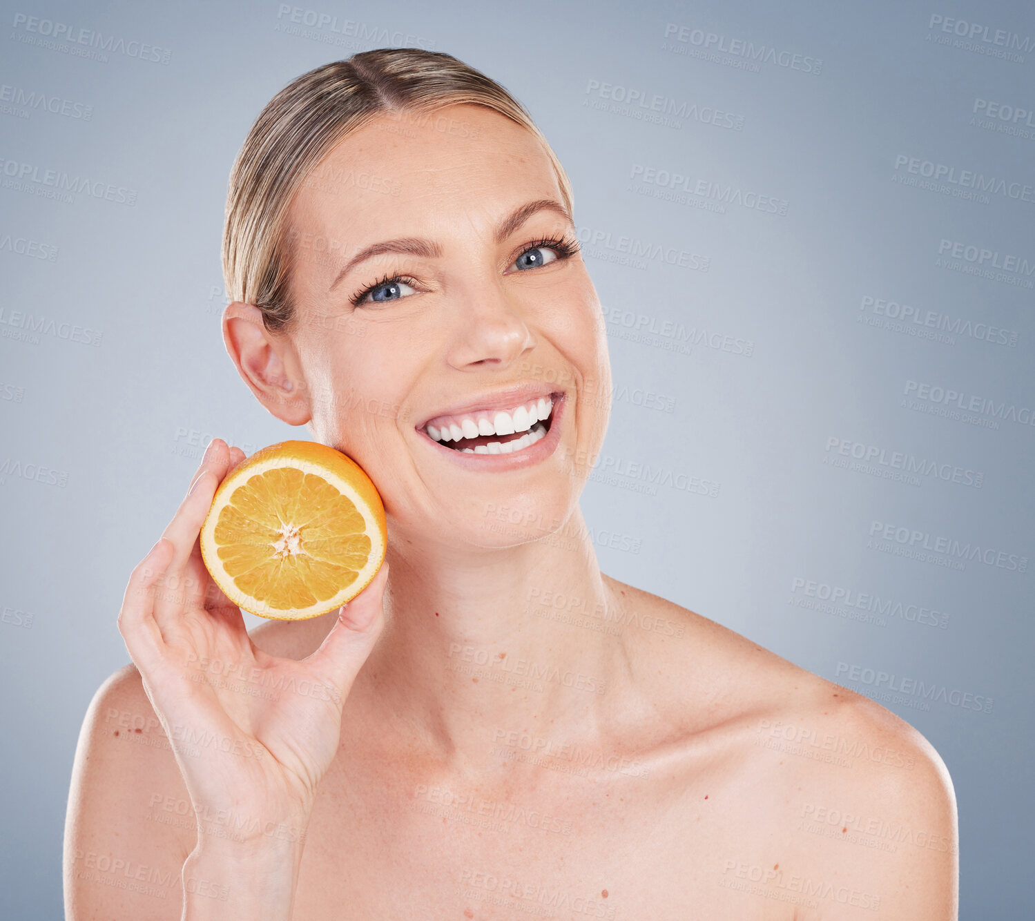 Buy stock photo Skincare, orange and portrait of woman in studio for facial treatment, natural glow or wellness on gray background. Smile, beauty and hand of model with fruit for vitamin c, organic or dermatology