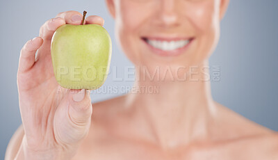 Buy stock photo Beauty, diet and apple in hand closeup for nutrition benefits in studio background with wellness. Healthy, eating and person with food for vitamin c, antioxidants and fruit for skincare and happiness