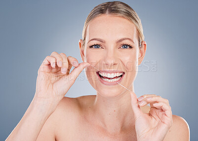 Buy stock photo Portrait, woman and floss in studio background for dental care, gum health and fresh breath. female model, plaque removal and tooth product for wellness, oral hygiene and prevention of cavities