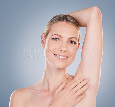 Buy stock photo Happy, woman and skincare with hand on armpit for laser hair removal, grooming and wellness in studio. Smile, female person or model and cleaning, hygiene or wash for dermatology on gray background