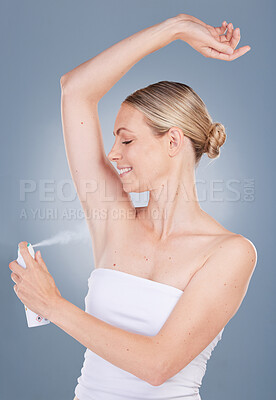 Buy stock photo Woman, armpit and smile with body spray in studio on grey background for fresh smell, wellness and wellbeing. Female person, deodorant and happy or satisfied for hygiene, body and self care or odor