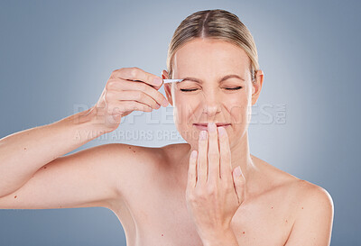 Buy stock photo Woman, tweezers and eyebrow with eyes closed in studio for beauty, shaping technique and maintenance for facial grooming. Girl, isolated and gray background with cosmetic tool for hair removal.
