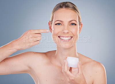 Buy stock photo Woman, face cream and jar in portrait by studio with application, cosmetics and beauty by mockup. Female model, collagen or skincare treatment with lotion, moisturizer and benefits by gray background