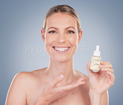 Buy stock photo Woman, portrait and smile with serum bottle for skincare in studio on grey background with routine, ingredients. Girl, natural and confidence with facial treatment, skin product and happy for results