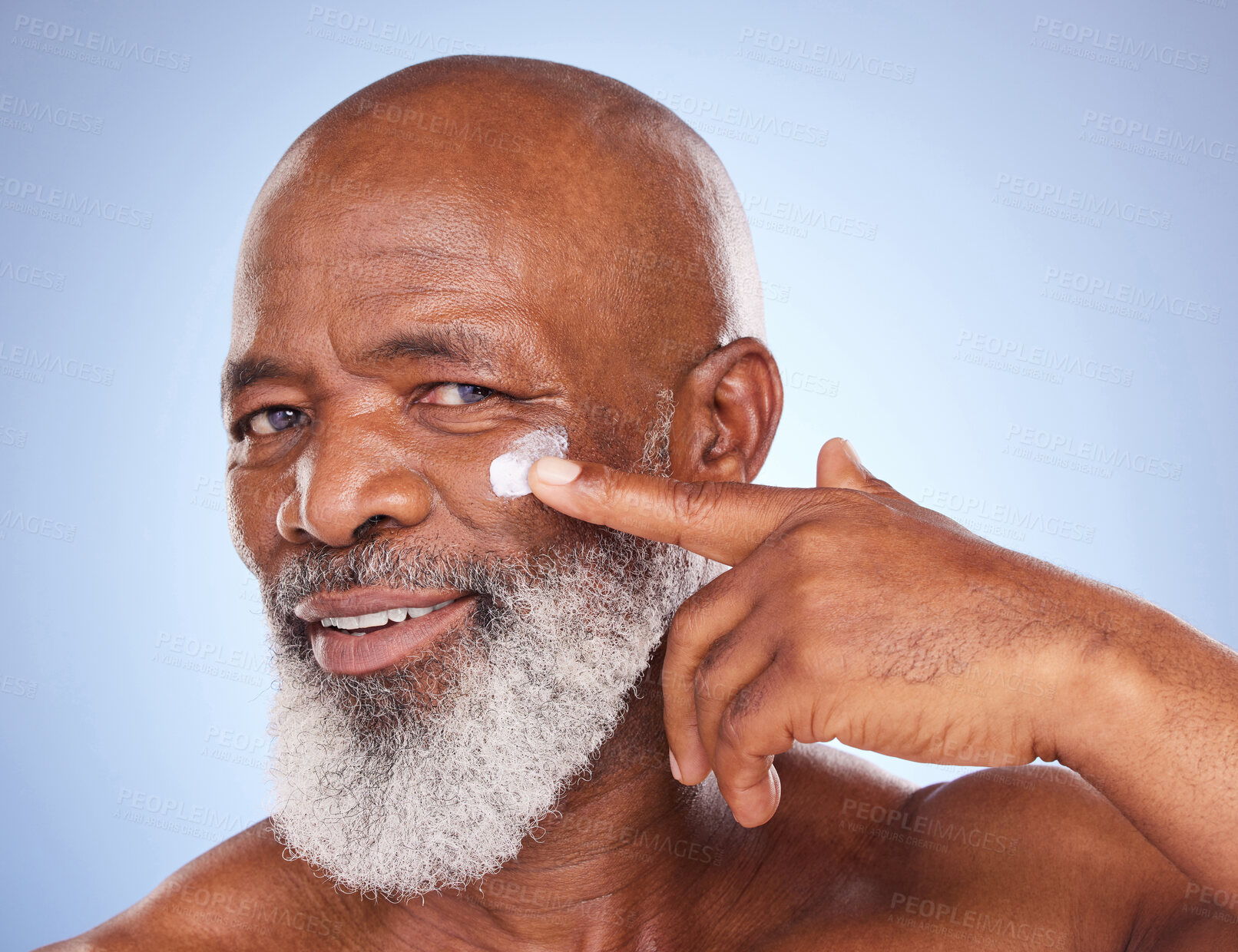 Buy stock photo Beauty, cream and portrait of black man in studio for sunscreen, anti aging or skincare. Cosmetics, mockup or self care with lotion on face of model on blue background for facial, spa and product