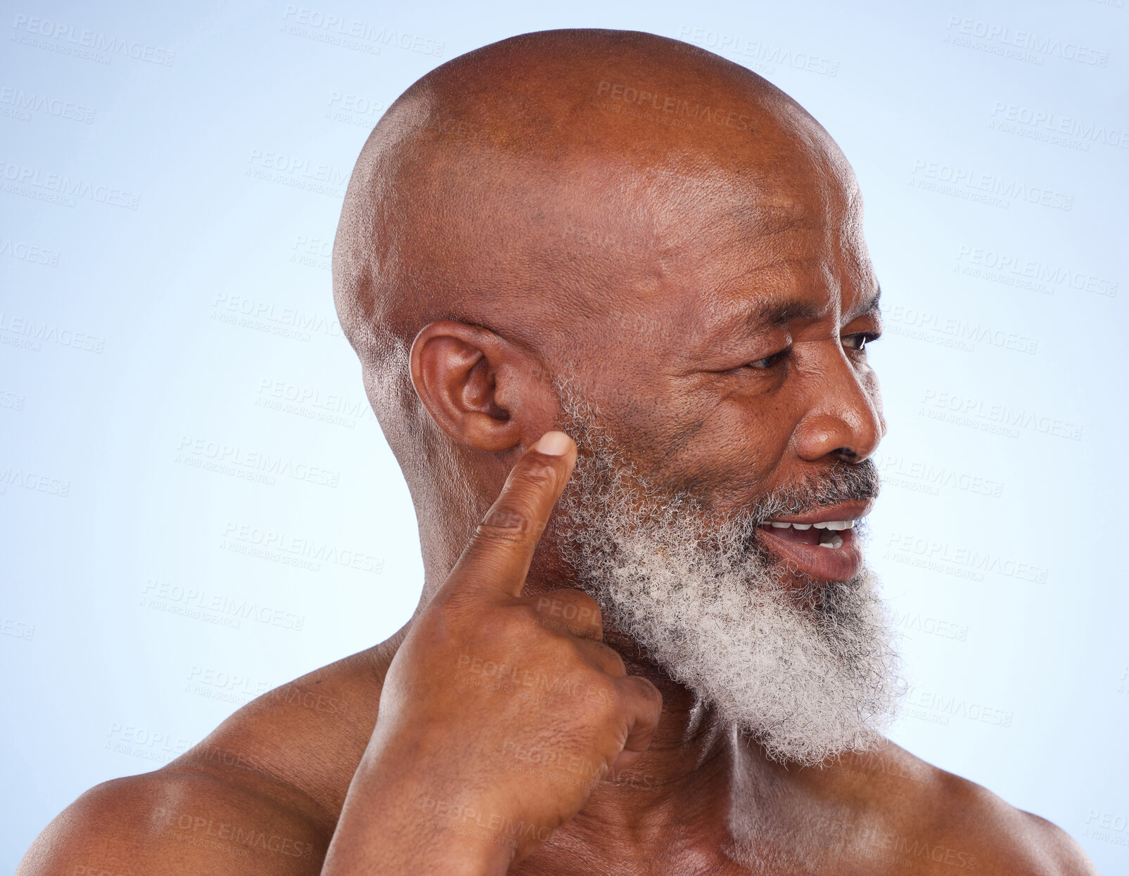 Buy stock photo Black man, studio and finger by ear for health or hearing, stop or wait and listen for sign. Male person, blue background and wellness with smile for facial treatment, beauty with natural cosmetics