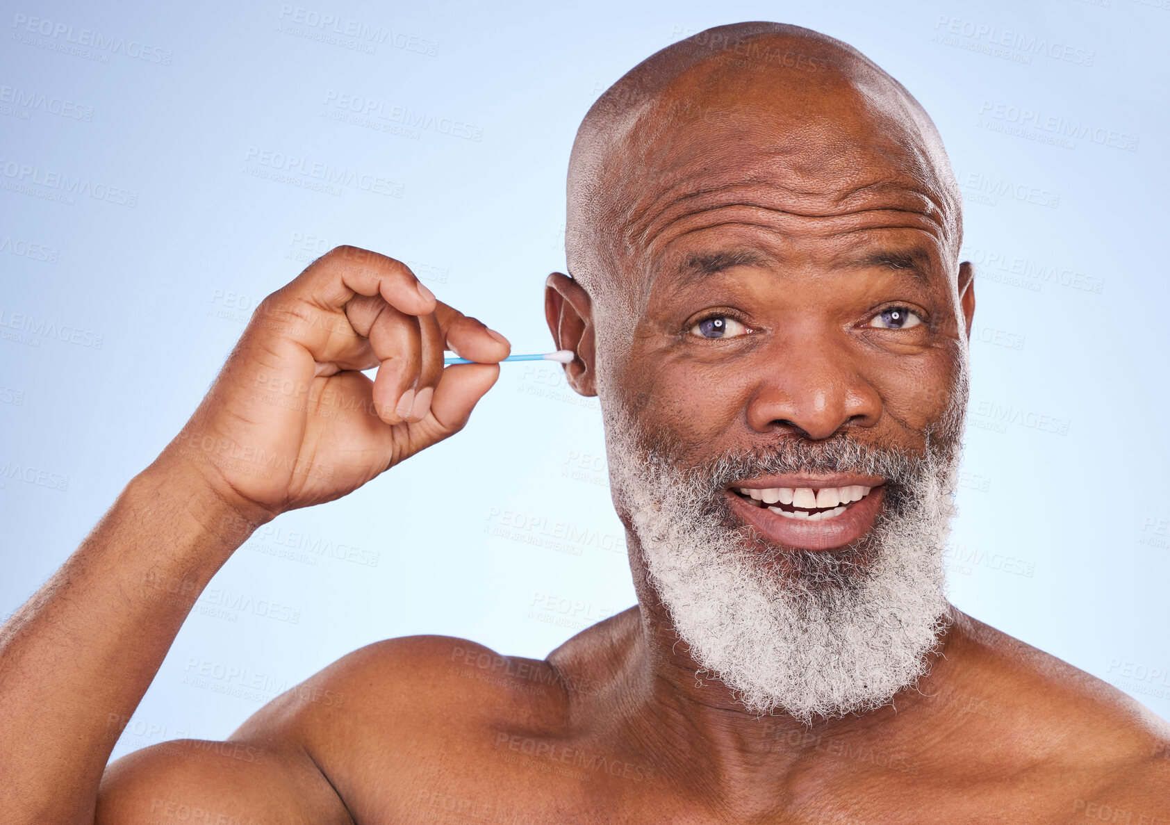 Buy stock photo Studio, portrait and black man with cotton swab for hygiene, self care maintenance and removal of wax. Happy, mature person and smile with product for cosmetics, health or cleaning on blue background