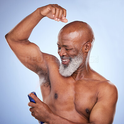 Buy stock photo Studio shot of a mature man applying deodorant to his armpit against a blue background