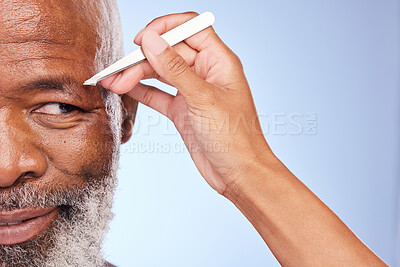 Buy stock photo Cropped shot of a mature man having his eyebrow tweezed by an unrecognizable woman  against a blue background