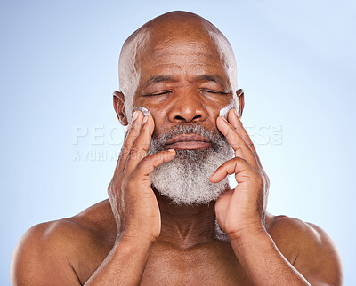 Buy stock photo Skincare, cream and beauty with black man in studio for sunscreen anti aging or spa. Cosmetics, mockup or self care with lotion on face of senior model on blue background for facial and product