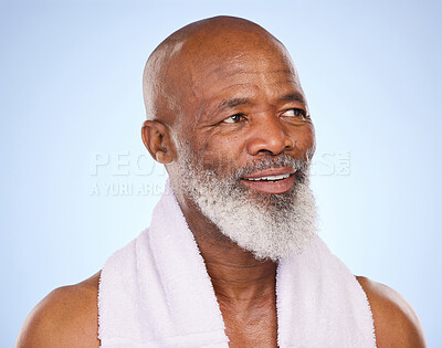 Buy stock photo Mature, black man and skincare with towel in studio from shower, cleaning and wellness for anti aging routine. Thinking, African person and idea of facial glow, beauty and sauna on blue background