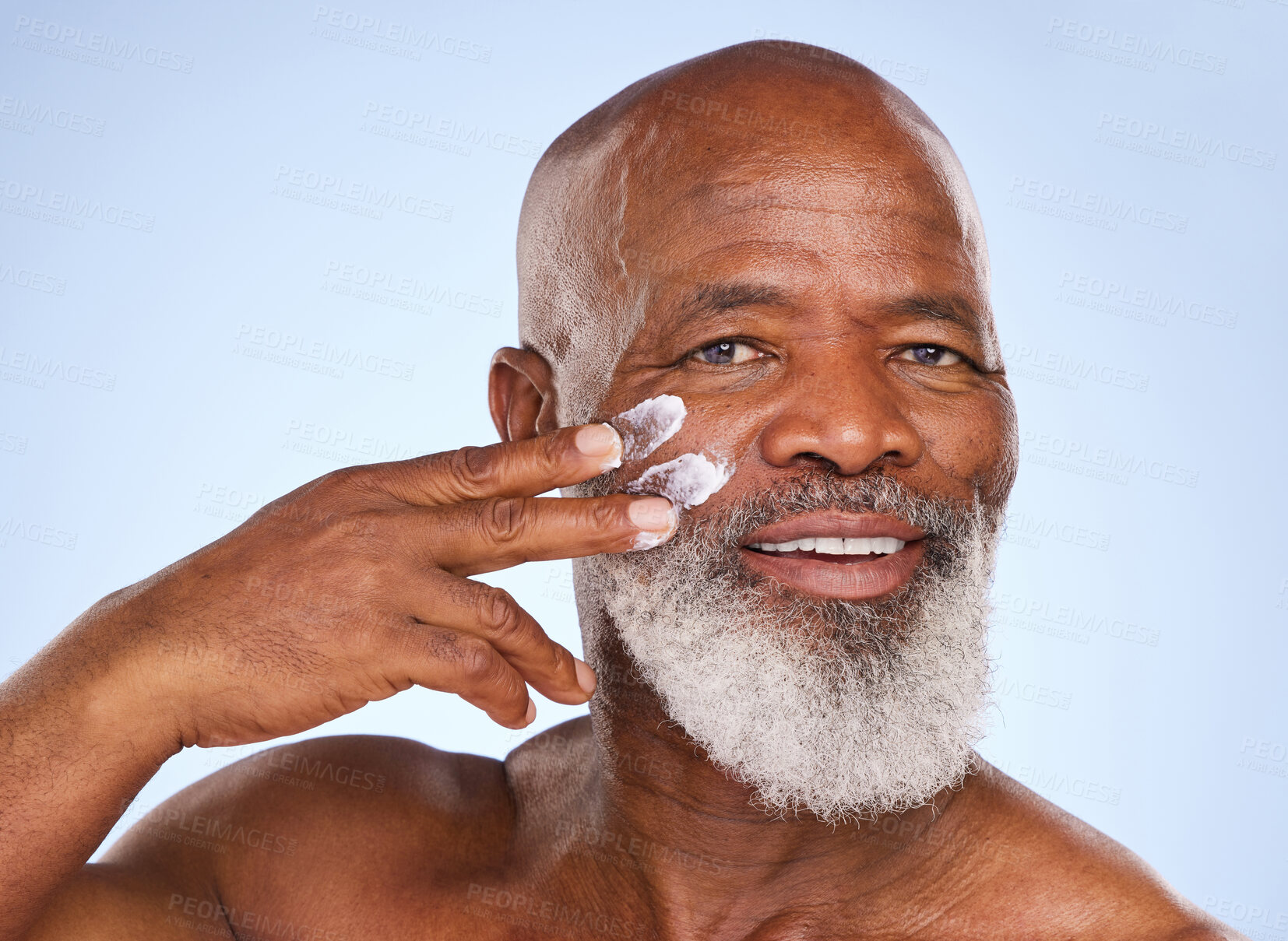 Buy stock photo Skincare, cream and sunscreen with portrait of  black man in studio for spa, anti aging or beauty. Cosmetics, mockup or self care with face lotion on model on blue background for facial and product