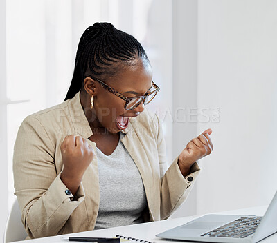 Buy stock photo Shot of a young businesswoman cheering while using a laptop in an office