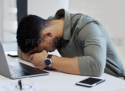 Buy stock photo Shot of a young businessman sleeping in an office at work