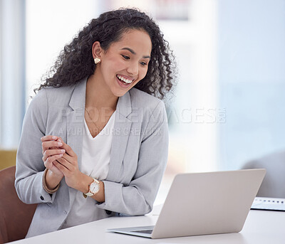 Buy stock photo Shot of an attractive young businesswoman sitting alone in her office and celebrating a success while using her laptop