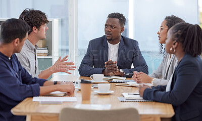 Buy stock photo Shot of a diverse group of businesspeople sitting in the office and having a meeting