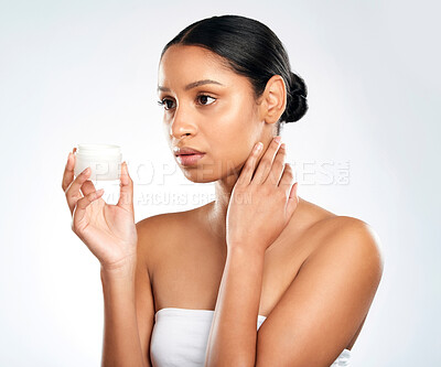 Buy stock photo Thinking, container and woman with cream, skincare and dermatology on white studio background. Person, model and girl with creme for dry skin, shine and glowing with cosmetics, beauty and wellness