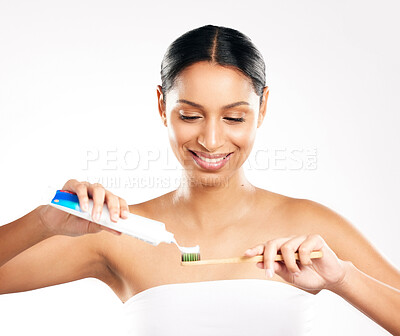 Buy stock photo Happy woman, toothbrush and toothpaste for clean teeth, dental or hygiene against a white studio background. Female person or model with product for brushing mouth, oral or gum care on mockup space