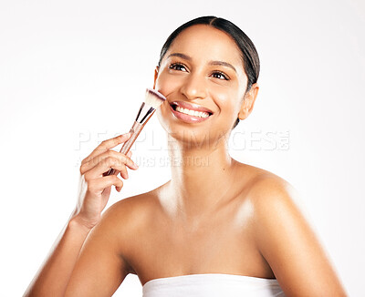 Buy stock photo Thinking, beauty or happy woman with brush for facial glow, makeup or skincare cosmetics in studio. Foundation product, white background and face of proud girl model with tools, smile or wellness