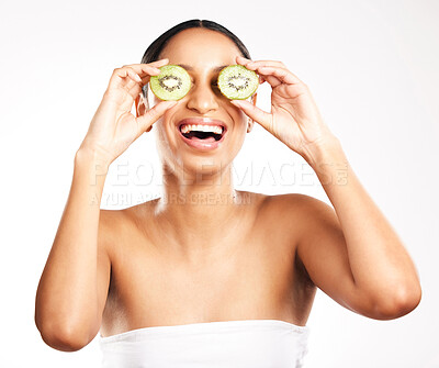 Buy stock photo Happy woman, face and kiwi for vitamin C, skincare or diet against a white studio background. Female person or model with smile and natural fruit for healthy nutrition, collagen or facial treatment