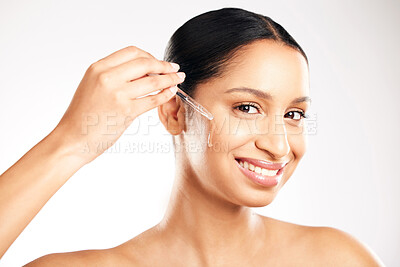 Buy stock photo Happy woman, face and serum for skincare, hydration or healthcare in retinol dermatology against a grey studio background. Portrait of female person with dropper for vitamin C, collagen or facial oil