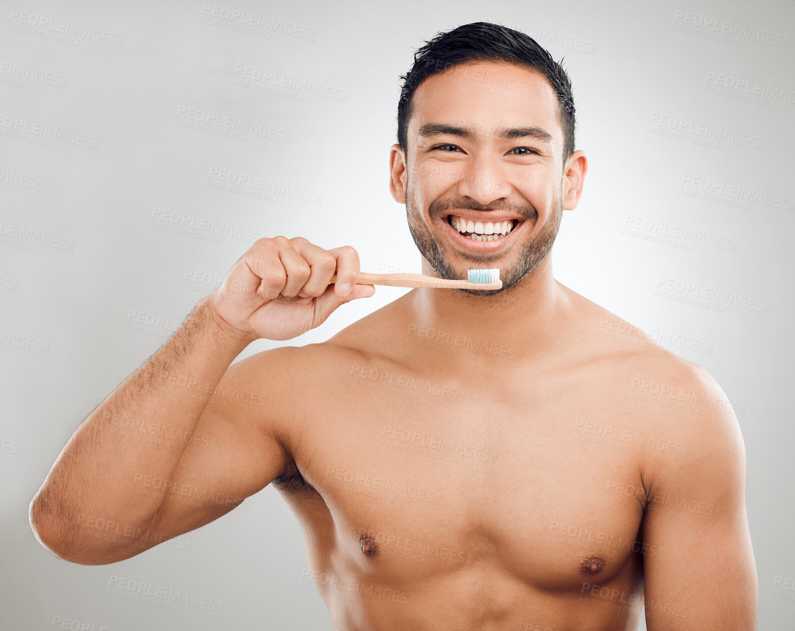 Buy stock photo Man, portrait and toothpaste on brush for teeth whitening results with wellness, healthy gums and hygiene in studio. Asian guy, dental product and cleaning mouth for fresh breath by white background