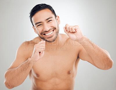 Buy stock photo Man, portrait and floss for oral care in studio, orthodontics and cosmetics for smile on white background. Male person, dental health and string for grooming, cleaning and gum or thread for plaque