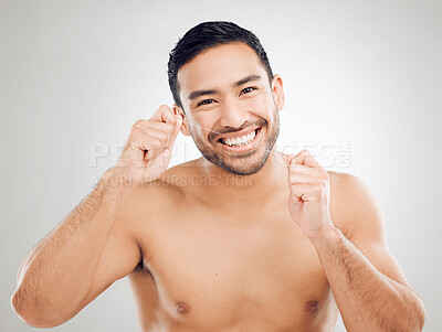 Buy stock photo Man, portrait and floss teeth in studio, orthodontics and cosmetics for smile on white background. Male person, dental health and string for grooming, cleaning and self care or thread for plaque