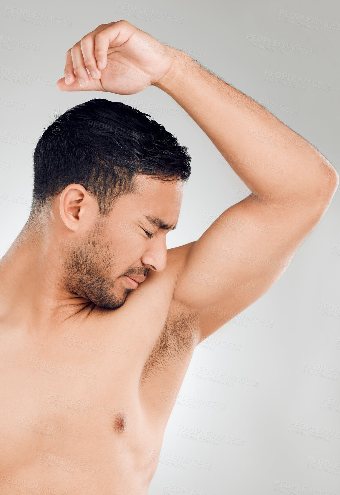 Buy stock photo Grooming, man and armpit with bad smell in studio for routine, wellness and skincare for hygiene on white background. Male person, underarm and stink of sweat or body odor for fragrance or cologne
