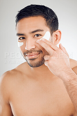 Buy stock photo Man, portrait and eye mask in studio or pads, facial treatment and hydration on white background. Male person, skincare and beauty for moisture, hyaluronic acid and patches to pamper or cosmetics