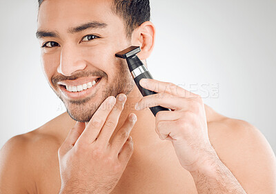 Buy stock photo Electric, shaving and portrait of asian man in studio for morning routine, wellness or natural treatment on white background. Grooming, hands and model with razor for confidence, facial or skincare