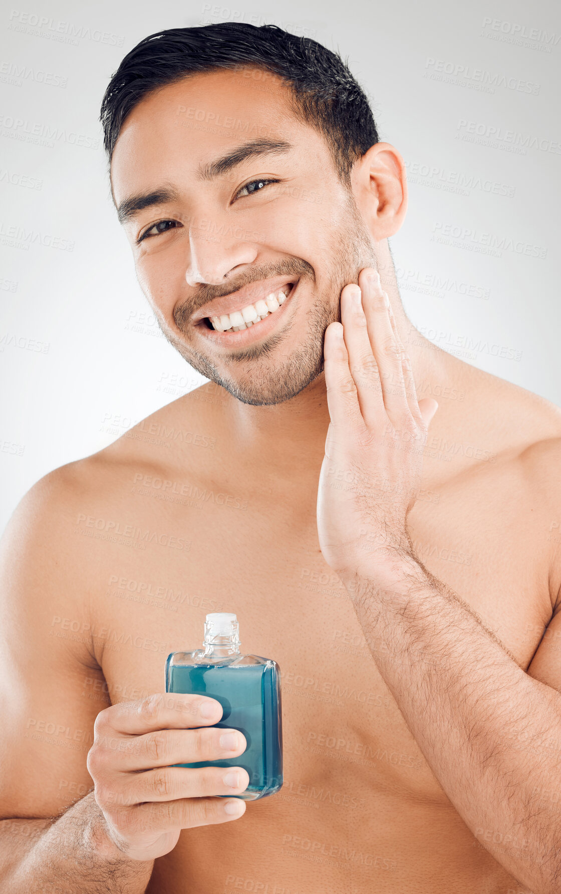 Buy stock photo Portrait, man and bottle of aftershave with skincare for razor burn and hair removal in studio. Dermatology, male person and cosmetics product for sensitive skin and cleaning face by white background