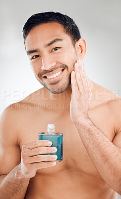 Buy stock photo Cologne, portrait and Asian man in studio for cosmetics, routine and confidence for perfume. Hygiene, male model and product for glow, shine and wellness or pride for dermatology by white background