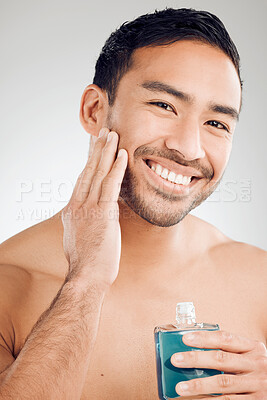 Buy stock photo Skincare portrait, man and bottle of aftershave for hair removal, razor burn and beard in studio. Dermatology, Asian guy and cosmetics product for sensitive skin and cleaning face by white background