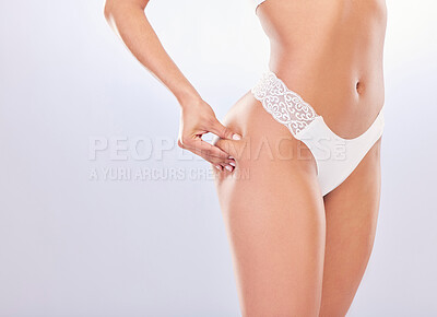 Buy stock photo Cropped shot of an unrecognisable woman standing alone in the studio and posing in her underwear