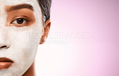 Buy stock photo Studio shot of an attractive young woman having a facial against a pink background