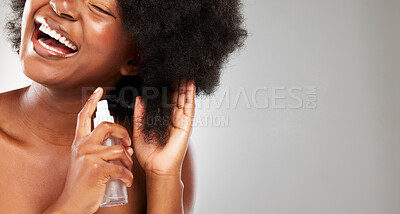 Buy stock photo Afro, grooming and black woman with hair product in studio for cosmetics, growth treatment or frizz control on gray background. Body, hands and model with spray bottle for natural, shine or mockup