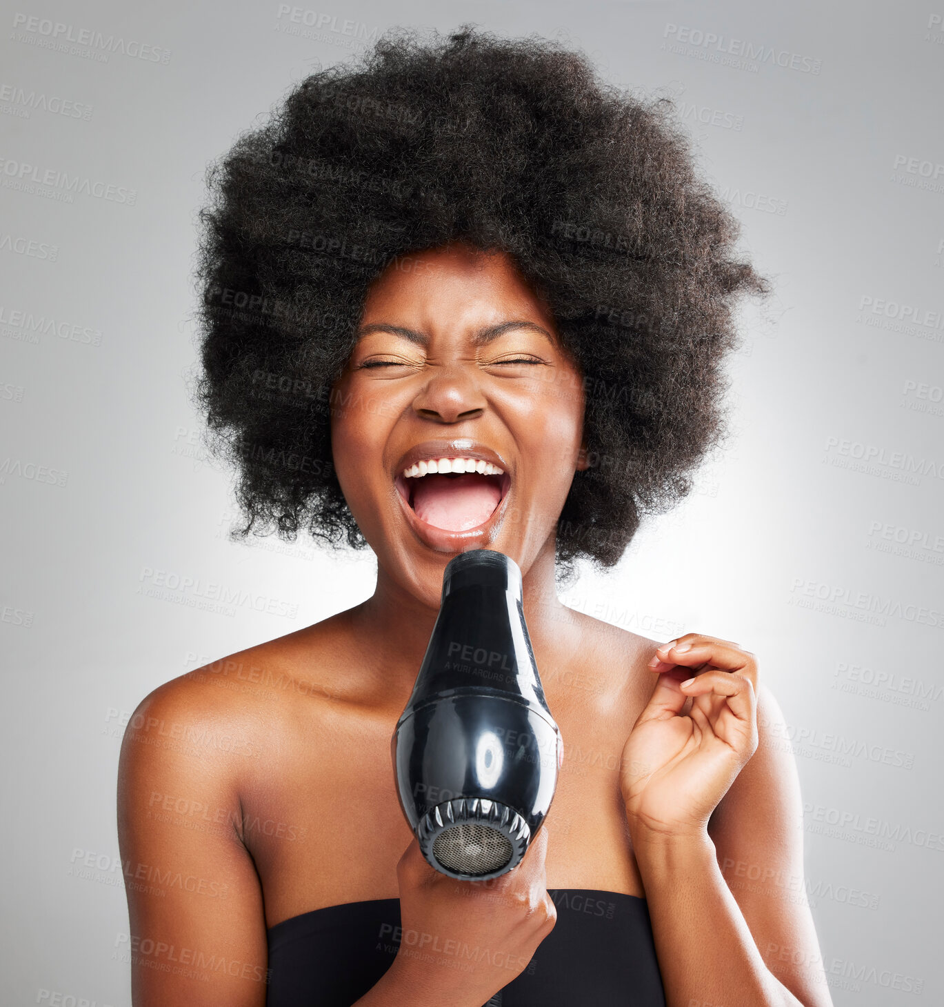 Buy stock photo Afro, dryer and black woman with singing, cosmetics and dermatology on grey studio background. African person, model or girl with equipment, shouting and natural beauty with healthy scalp or grooming