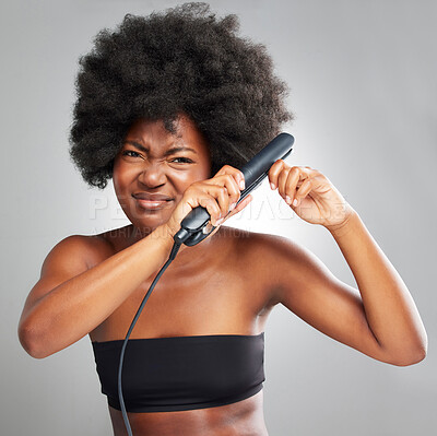 Buy stock photo Black woman, frustrated and hair in studio with straightening iron for afro, change or heat by white background. African person, model or girl in portrait, products and stress with hairstyle