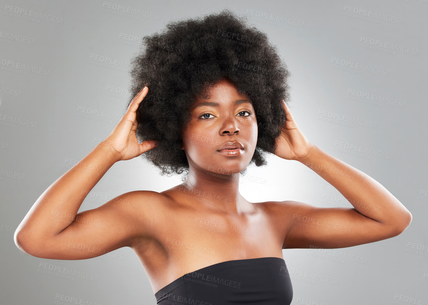 Buy stock photo Hair care, afro and studio portrait of African woman with glow, shine and texture from treatment. Model girl, face and pride for beauty, wellness and luxury transformation in salon by grey background