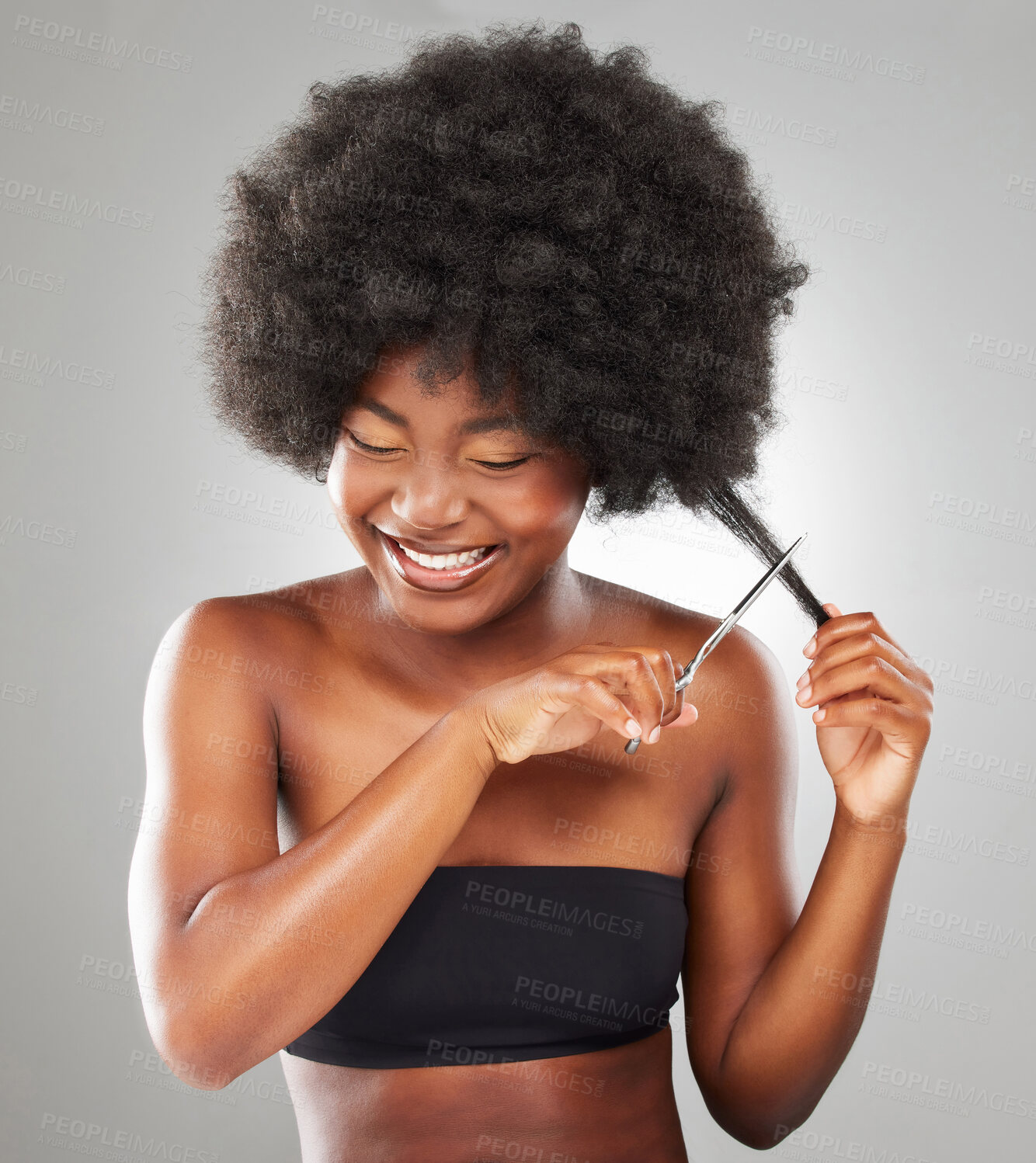 Buy stock photo Happy, natural and black woman with scissors for cutting, healthy growth or treatment for hairstyle. Female person, wellness and volume for texture or cosmetics for afro aesthetic on gray background
