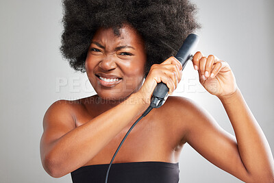 Buy stock photo Woman, frustrated and hair care in studio with straightening iron for afro, change or heat by white background. African person, model or girl in portrait, product or stress with results for hairstyle