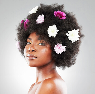 Buy stock photo African woman, flowers and hair in studio portrait for spring, growth and health by white background. Girl, model or person with glow, daisy and peony plants with color, afro and hairstyle for change